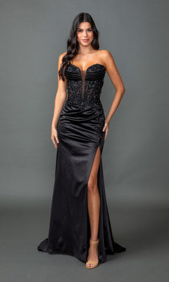 A woman in the Lace-Up Long Black Prom Dress: Dancing Queen 4555, featuring a strapless corset bodice with beaded embroidery, poses against a plain gray background.