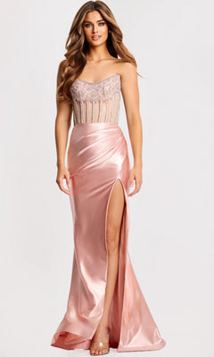 A woman wears the Jovani 45593 long prom dress—a blush pink satin gown with a beaded bodice, spaghetti straps, and a high-leg slit skirt.