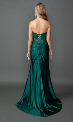 A woman wearing the Long Prom Dress: Dancing Queen 4560—a strapless dark green gown with a lace-up back and subtle ruching—stands with her back to the camera against a plain gray background.