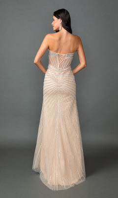 A woman stands against a plain gray background in the Dancing Queen 4562 long prom dress—a strapless, floor-length nude gown with a corset bodice, silver embellishments, and lace-up back detail.