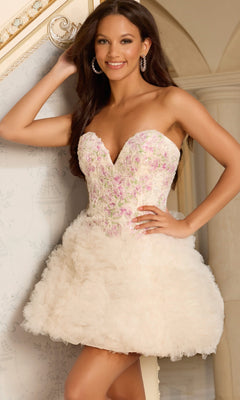Woman posing indoors and smiling at the camera in the Jovani 45637 Short Homecoming Dress, featuring a strapless fit-and-flare silhouette with a floral-embroidered corset bodice and a ruffled skirt.