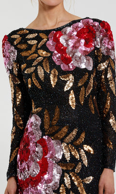 A person wearing the Mac Duggal 4566 Long Sleeve Sequin Formal Gown, a black evening dress adorned with large red and pink sequin flowers and gold sequin leaves.