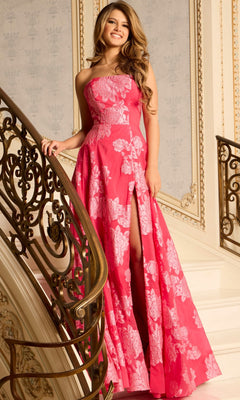 A woman in a strapless fuchsia Jovani 45721 long prom dress with jacquard fabric stands on a staircase with ornate golden railings, smiling at the camera.
