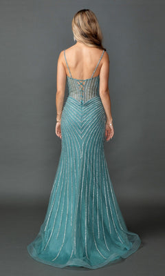 A woman with long hair stands facing away, wearing the Dancing Queen 4574—a sleeveless, teal, floor-length prom dress. This gown features thin straps and silver beaded lines arranged in an elegant chevron pattern, creating a stunning beaded prom look.