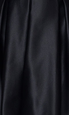 Close-up of smooth, black fabric with a slight sheen and soft folds—a luxurious detail found on the Lace-Up Short Hoco Dress: Blondie Nites 4578BN, perfect for a junior cocktail or short party dress with pockets.