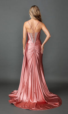 A woman is seen from behind wearing the Long Prom Dress: Dancing Queen 4581—a shiny, floor-length rose-colored gown with thin straps, a ruched back detail, and a sleek satin sheath skirt—set against a plain gray background.