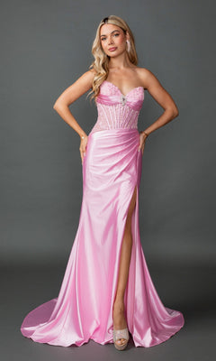 A woman poses against a plain gray background wearing the Long Prom Dress: Dancing Queen 4587 in pink—a strapless satin gown featuring a sheer corset bodice with floral details, a fitted sheath skirt with a thigh-high slit, and paired with peep-toe heels.