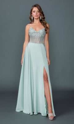 A woman in a sage Long Prom Dress: Dancing Queen 4589 with a beaded corset bodice and thigh-high slit pairs it with silver heels, posing against a plain gray background.