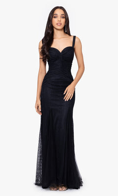 A woman stands facing forward, wearing the Long Prom Dress 4591BN by Blondie Nites—a black lace fitted gown with thin straps, a sweetheart neckline, and a chic lace-up back for an elegant formal look.