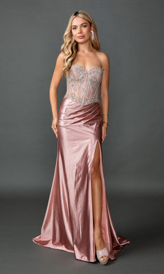 A woman wearing the Long Prom Dress: Dancing Queen 4594 in rose gold, featuring a strapless metallic finish with a sheer embellished corset bodice and a dramatic high slit, stands against a plain dark background. This glamorous floor-length gown perfectly blends elegance and allure.