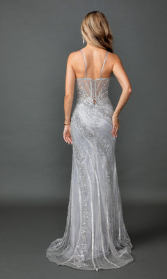 A woman is shown from the back, standing against a gray background, wearing the Dancing Queen 4599 long prom dress—a silver, floor-length sheath gown featuring thin straps and sparkling sequin detailing.