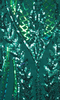 Close-up of the green fabric on the Blondie Nites 4610BN Long Sequin-Print Prom Dress, detailed with intricate geometric and leaf-patterned sequin and bead embroidery.