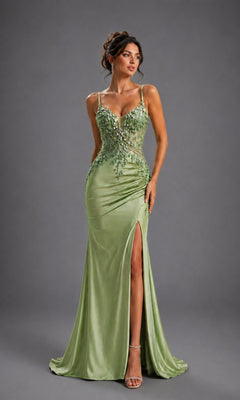 A woman wearing the Dancing Queen 4614 long prom dress in sage—a satin gown featuring floral embellishments, thin straps, a corset-style bodice, and a thigh-high slit—paired with open-toe heels and standing against a neutral gray background.