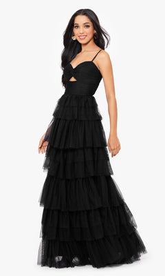 Woman modeling the Long Ruffled Prom Dress: Blondie Nites 4637BN—a sleeveless, floor-length black tiered tulle gown with a sweetheart bodice, thin straps, and a front cutout—posing against a white background.