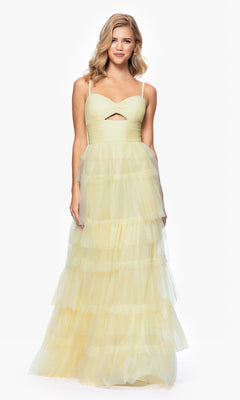 A woman stands against a white background wearing the Blondie Nites 4637BN Long Ruffled Prom Dress—a sleeveless, floor-length pale yellow tulle gown with spaghetti straps, sweetheart bodice, and small front cutout.