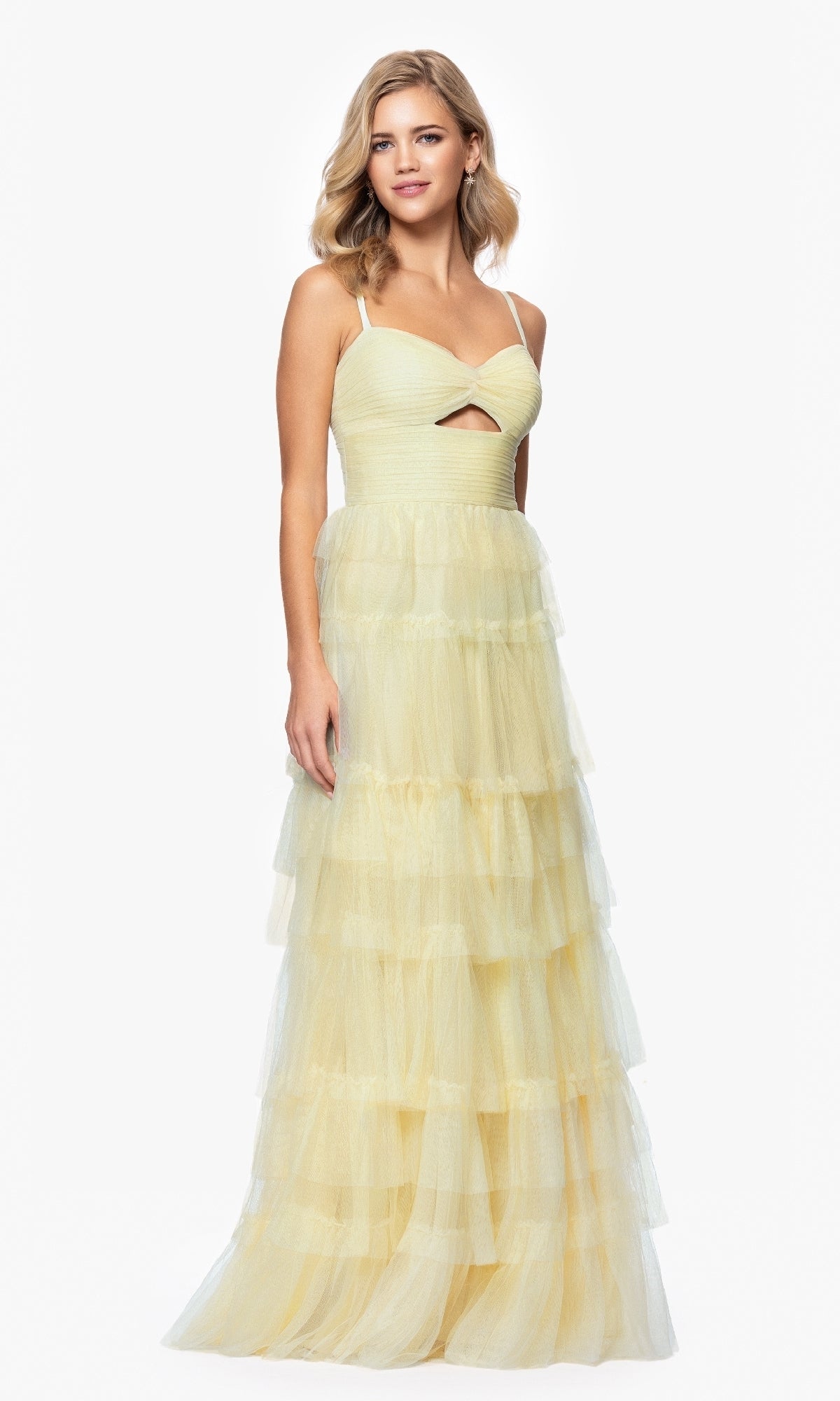 A woman stands against a plain white background wearing the Blondie Nites 4637BN long ruffled prom dress in light yellow, featuring a sleeveless design, fitted sweetheart bodice with front cutout, and a tiered tulle A-line skirt.