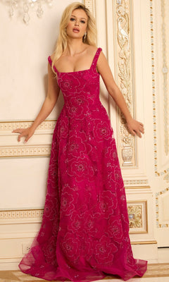 A woman stands against an ornate cream-colored wall wearing the Jovani 46471 long prom dress—a sleeveless, floor-length fuchsia gown with intricate floral embroidery and sequin details.