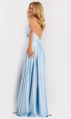 A woman in the Jovani 46483 long prom dress—light blue, strapless satin A-line style with beaded trim—smiles over her shoulder against a white background.
