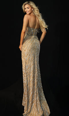 A woman with long blonde hair models the Jovani 46928, a fully embellished long prom dress with an asymmetrical sheer panel and high leg slit, smiling over her shoulder against a black background.