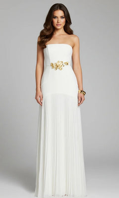 A woman stands against a plain light grey background, wearing an off-white Jovani 47000 long formal dress with a strapless pleated design, gold floral waist detail, and a gold bracelet.