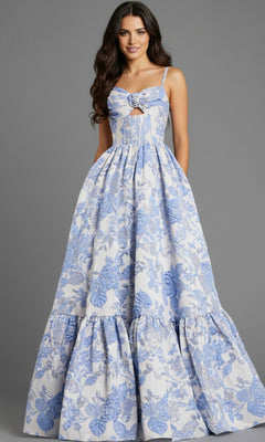 A woman stands against a gray background wearing the Jovani 47328 long prom dress—a floor-length, sleeveless white floral jacquard gown with a fitted bodice and a-line skirt.
