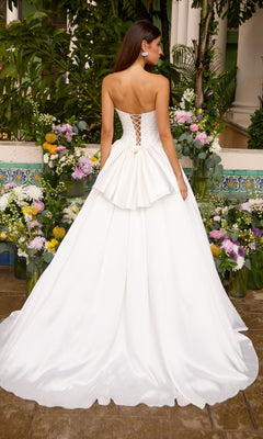 Back view of the Long Prom Dress: Ava Presley 47364, a strapless white floor-length ball gown featuring a lace-up corset back and a waist bow.