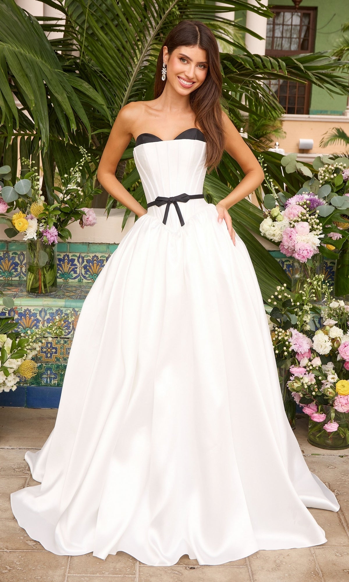 Ava Presley 47365 strapless ivory ball gown featuring a black sweetheart neckline and a black waist bow.