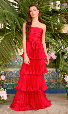 Strapless red Ava Presley 47367 gown featuring a pleated, tiered skirt and a bow at the waist.
