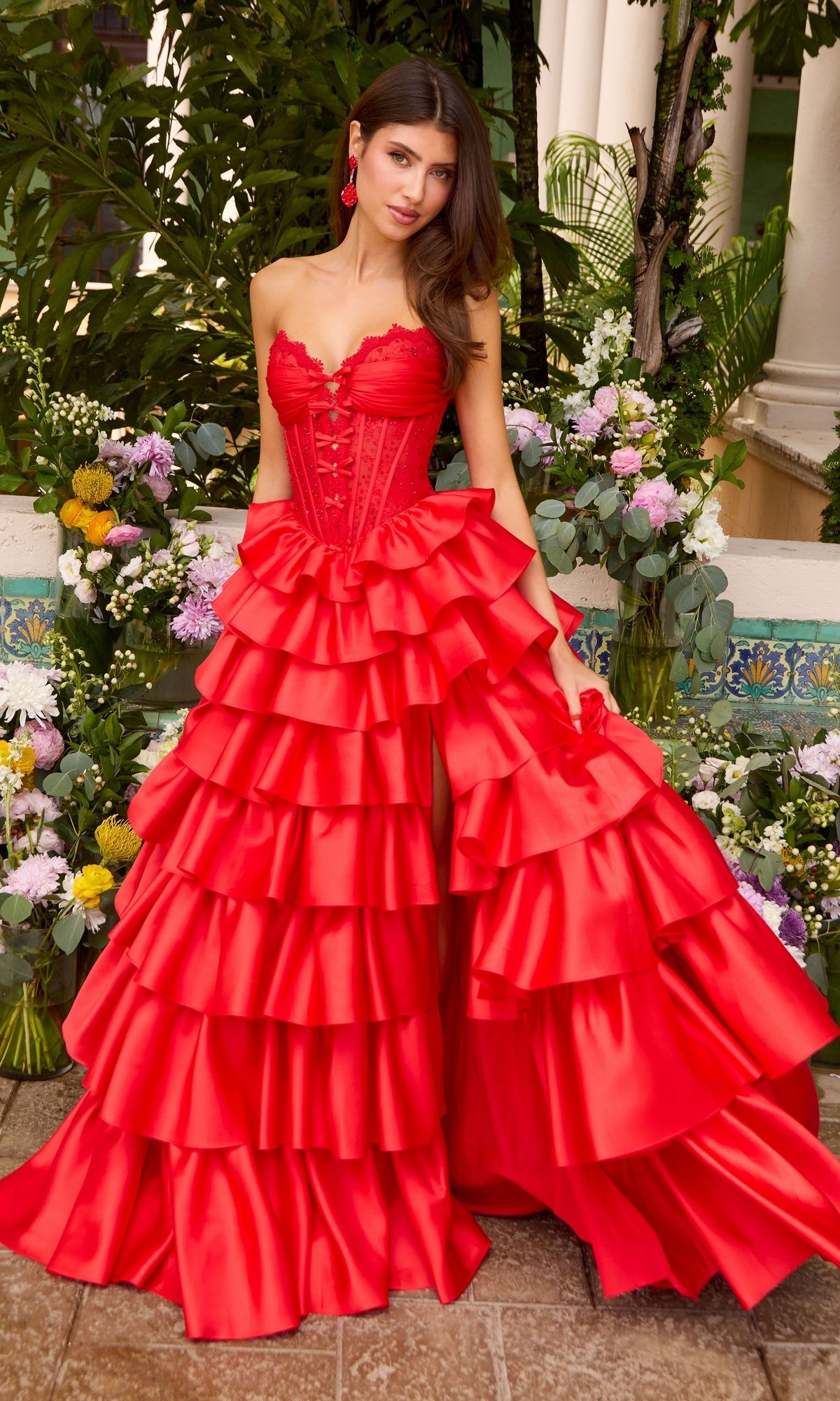 Red Ava Presley 47372 strapless corset prom dress with a multi-tiered ruffled skirt and a high leg slit.