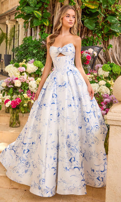 A person wearing a Long Prom Dress: Ava Presley 47377, a floor-length ballgown with a white and blue floral print, a corset-style bodice, and a front cutout.