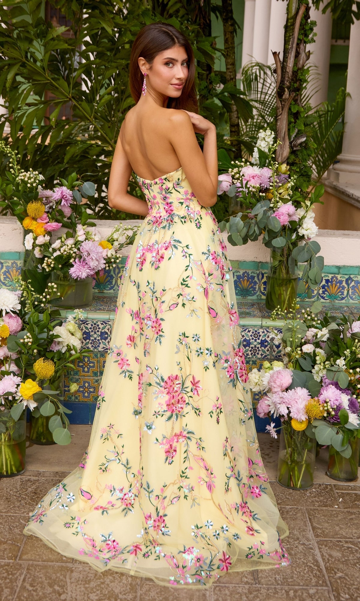 The Long Prom Dress: Ava Presley 47391 is a strapless, floor-length yellow gown featuring a pink and green floral embroidery pattern.