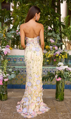 Back view of the Long Prom Dress: Ava Presley 47395, a yellow mermaid gown featuring a strapless floor-length silhouette with layered pastel flower appliqués.