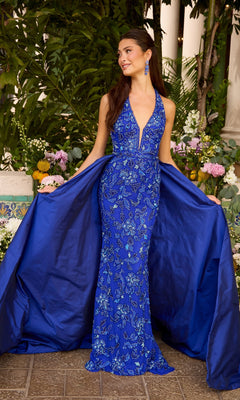 Ava Presley 47421 floor-length, royal blue beaded halter prom dress with a plunging neckline, intricate beadwork, and a dramatic overskirt.