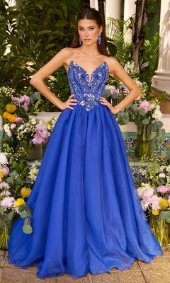 A person wears a royal blue Long Prom Dress: Ava Presley 47430 with a beaded, V-neck bodice and a full-length, flowing skirt.