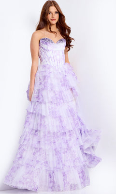A woman models the Jovani 47440 long prom dress, featuring a strapless corset bodice and lavender tiered skirt with sparkling embellishments and floral print, standing against a plain white background.