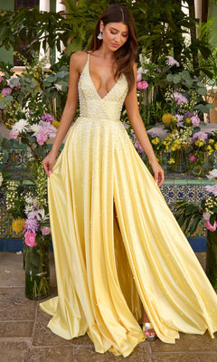 A person wearing the yellow pearl Ava Presley 47459 A-line prom dress, featuring a floor-length skirt with a front slit, a deep V-neckline, and a beaded bodice.