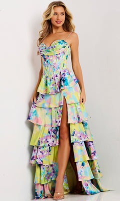 A woman wearing the Jovani 47560 long prom dress in print, featuring a corset bodice and tiered ruffle skirt, stands against a white background.
