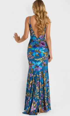 A woman stands facing away from the camera wearing the Jovani 47655 long prom dress, featuring blue sequin florals, a deep V-back, and a sleeveless design.