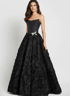 A woman wearing the Jovani 47695 long prom dress, featuring a strapless corset bodice, 3D rosette skirt, and a small silver waist bow, stands against a plain background.