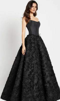 A woman in the Jovani 47695 long prom dress with a strapless corset bodice and a flowing 3D rosette skirt.