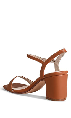 The True Tan Prom Shoes: Touch Ups 4771 are brown block-heeled sandals with a thin ankle strap, buckle closure, and open toe, shown from a back side angle.
