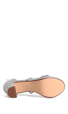 The Tabbie Silver Prom Shoes (Touch Ups 4778) feature a smooth beige sole, crystal-embellished straps, and a textured block heel—shown from the bottom for added detail.