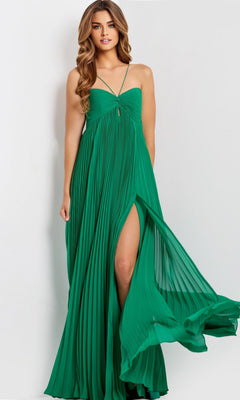 A woman stands against a plain light background wearing the Jovani 47820, a sleeveless green long prom dress with pleats and a thigh-high leg slit.