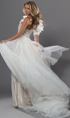A woman poses against a gray background wearing the Jovani 47895 long formal dress, featuring a flowing off-white design with a sheer train and feathered shoulder detail.