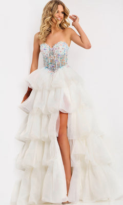 A woman poses in the Jovani 48177 Long Prom Dress, featuring a strapless white gown with a beaded corset bodice, tiered tulle skirt, and high slit against a plain background.