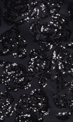 The Long Black Sequin Prom Dress (Blondie Nites 4817BN) features black fabric with a shiny black floral sequin pattern—ideal for an affordable formal event or a stunning evening look.