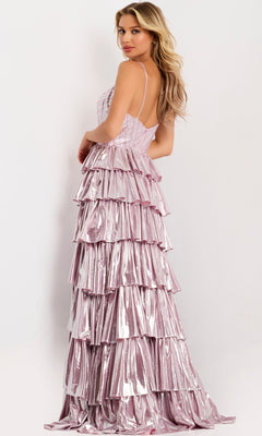 A woman stands sideways, looking over her shoulder, wearing the Jovani 48341 long prom dress—sleeveless and metallic pink with tiered ruffles—against a plain background.