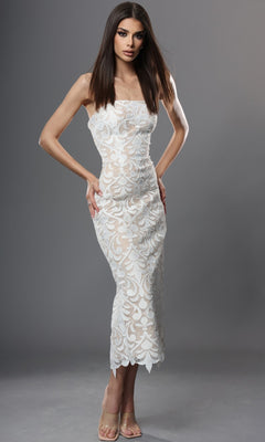 An elegant woman poses against a plain gray background in the Midi Semi-Formal Dress: Jovani 48461, a stunning off white/nude strapless lace dress featuring a form-fitting silhouette with a sheer floral pattern—making it the perfect choice for any special occasion.