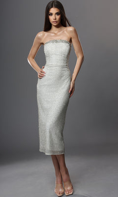 Woman standing in the Midi Semi-Formal Dress: Jovani 48559, an off-white, strapless midi dress featuring a fitted silhouette and textured pattern inspired by Jovani’s signature style, paired with clear high-heeled shoes against a neutral gray background.