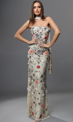 A woman models the Jovani 48587, a long formal gown in strapless ivory with colorful floral embroidery, featuring a light sheer overlay and a matching sheer neck scarf, set against a plain grey background.